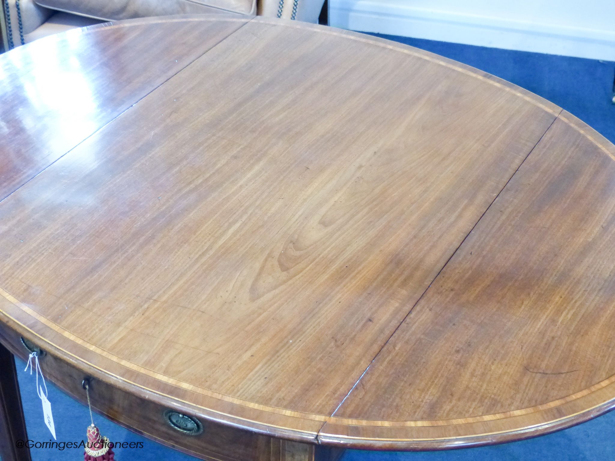 A George III Sheraton period mahogany and satinwood banded oval Pembroke table, 111.5 cm long when open, 83.5 cm deep, 72 cm high